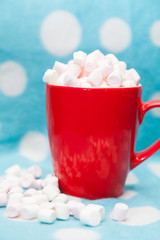 marshmallow in a red cup on a blue background