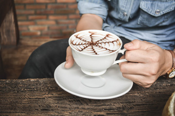 Women drinking hot coffee in coffee shop.selective focus and hip