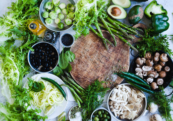 Raw Green Vegetables And Mushrooms Over The Kitchen Table. Diet,  Vegetarian Or Vegan Food Cooking Concept. Top View. Copy Space.