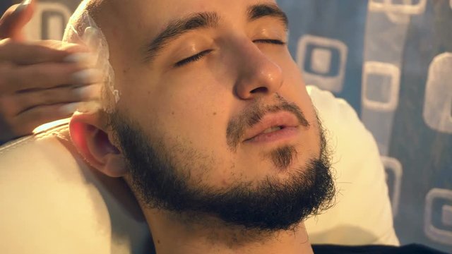 man during head shaving