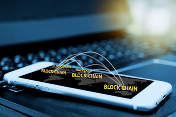 Digital money , blockchain and bitcoin concept. Block chain texts and network connect link and smartphone screen with blur laptop background , flare light