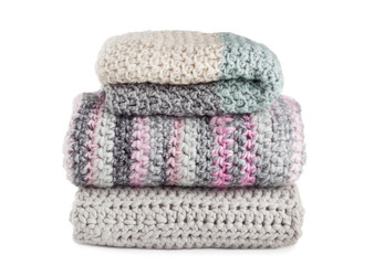 Stack of knitted scarfs isolated on white background