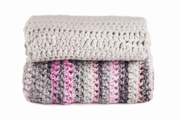 Stack of knitted scarfs isolated on white background