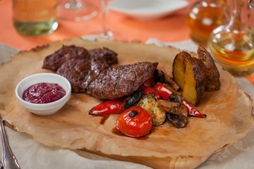 Food cooked on the grill. Baked meat with potatoes and vegetables