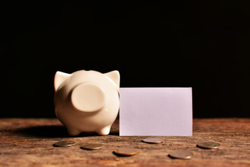 piggy bank with money on black background.