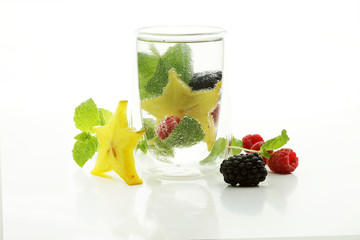 Full glass of water with lemon and mint isolated on white background