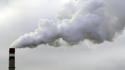 industrial chimneys emits toxic pollutants into the sky polluting the environment. - 127051833