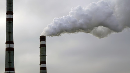 industrial chimneys emits toxic pollutants into the sky polluting the environment.