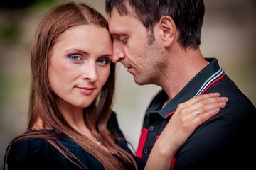 Young couple in love outdoor.Stunning sensual outdoor portrait of young stylish fashion couple posing in summer in field