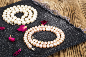 Pearl Necklace on wood background.