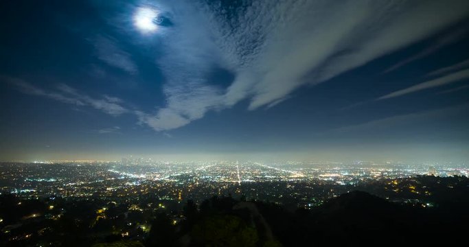 Los Angeles, California, USA - view from Griffith Observatory at City of Los Angeles facing south at clear night with moonlight and a few moving clouds - Timelapse without motion
