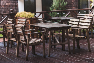 Outdoor cafe terrace with wooden furniture