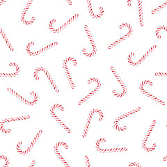 Vector seamless pattern with candy canes. Red striped Christmas peppermint sticks on white background.