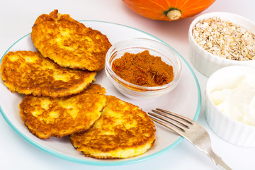 Pumpkin-oatmeal pancakes with curry on a white background