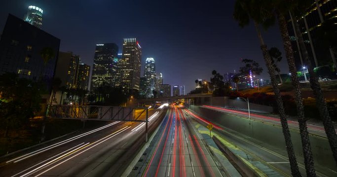 Los Angeles, California, USA - Light trails of passing cars at Freeway 110 - view from Bridge 3rd St. at Financial District facing southwest at night - Timelapse without motion