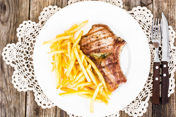Loin Roast with Potatoes Fries on White Plate