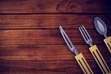 Composite image of plastic knife, fork and spoon
