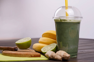 healthy smoothie with bananas,lime and ginger lie on the table