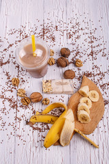 healthy brown smoothie with walnut and fruits lie on the table