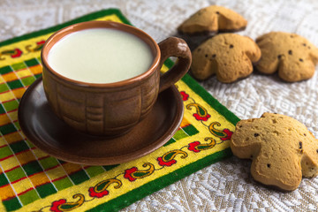 Breakfast in a rustic style, milk, biscuits, fruit in pottery