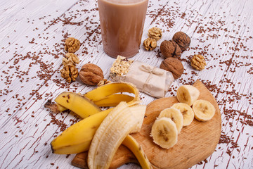 healthy brown smoothie with walnut and fruits lie on the table