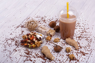 healthy brown smoothie with walnut and candied fruits lie on the