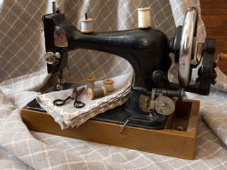 An old antique sewing machine, thread, scissors