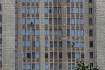Fototapeta premium Window washers on the facade/ workers cleaning company while working 