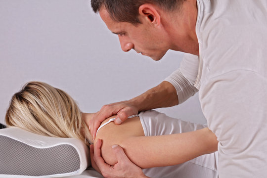 Woman having chiropractic back adjustment close up. Osteopathy, Alternative medicine, pain relief concept