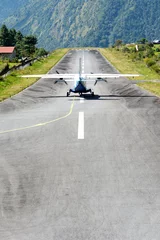 Papier Peint photo Aéroport The aircraft on the runway of the Tenzing-Hillary airport Lukla - Nepal, Himalayas.