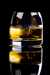 whiskey on black background with reflection