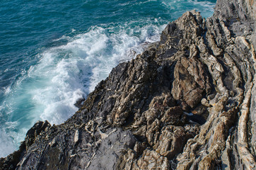 static rocky textures and dynamic sea water meet at the mediterranean coastline of Nervi in Genoa, Italy