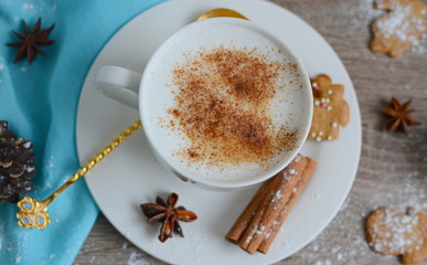Cup of cappuccino with christmas decorations on wooden table