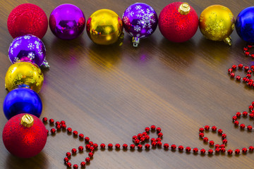 New Year's multi-colored Christmas balls on table.