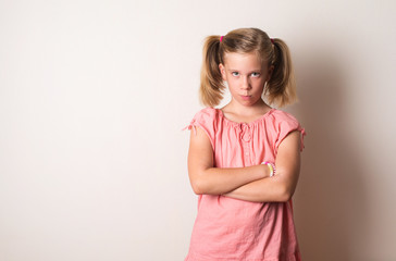 Frowning naughty girl with arms crossed. Sad, depressed, stressed