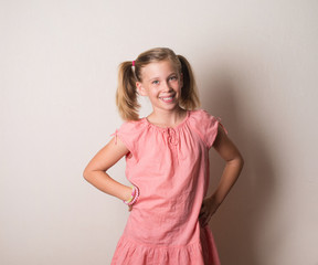 Happy smiling girl in pink dress portrait