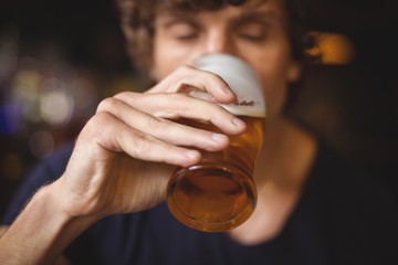 Close-up of a man drinking beer in the restaurant