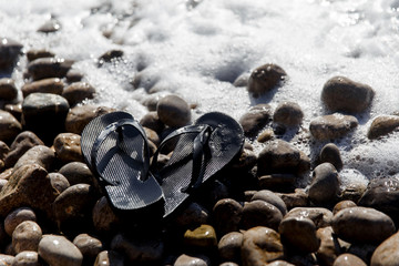 Flip-flops on pebble beach day