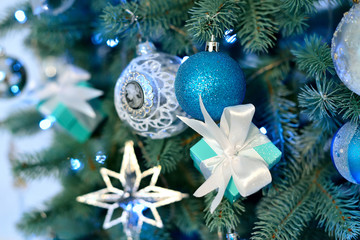 Decorated christmas tree with blue vintage balls and light.