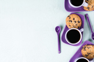Purple coffee cup with saucer and spoon on light blue background