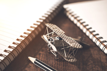 vintage model plane on wood table with notebook and notepad free