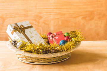Gift boxes with Christmas decoration on wooden table background.
