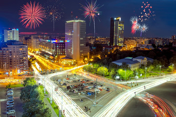 Fototapeta na wymiar Victoria Square in Bucharest, Romania with fireworks in the sky.