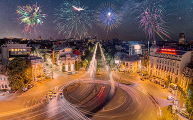 Romana Square in Bucharest, Romania with fireworks in the sky.