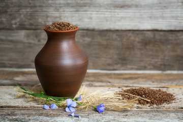 Close-up of flax seeds in a earthen jug