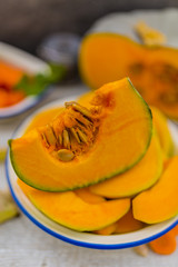 Portions pumpkin on the table in the kitchen ready to cook.