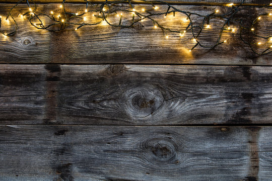 winter decorative light on old rustic wooden timbers, flat lay
