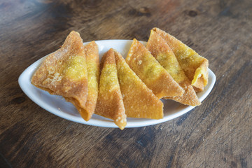 Deep fried dumplings in white dish