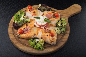italian pizza calzone with tomato, salad and mozzarella