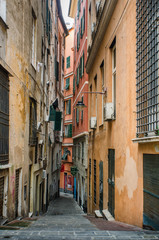 A typical narrow street in the old part of the ancient city of Genoa, Italy